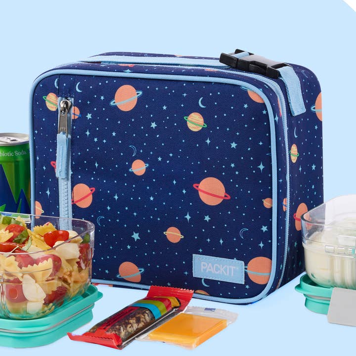Space-themed lunch bag with snacks and drinks on a light blue background