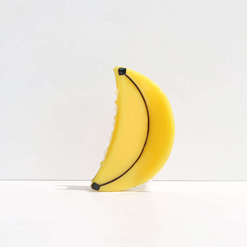 Yellow banana-shaped object on a white background
