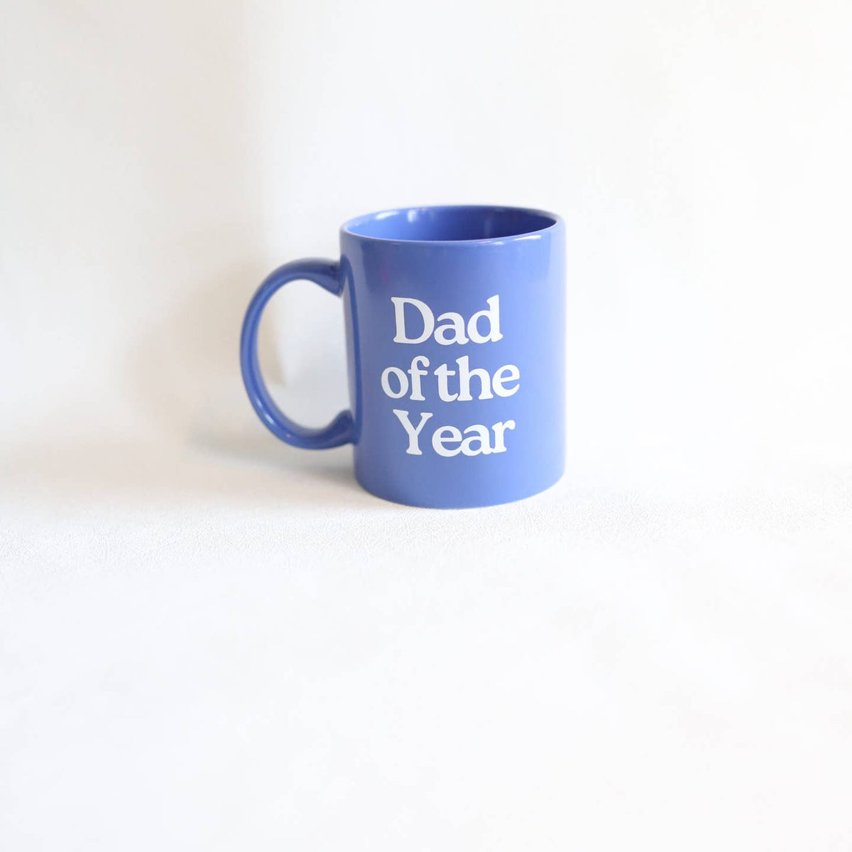 Blue mug with 'Dad of the Year' text on a white background