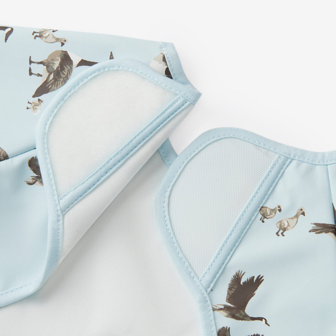 Fabric swatches with bird pattern on a light blue background