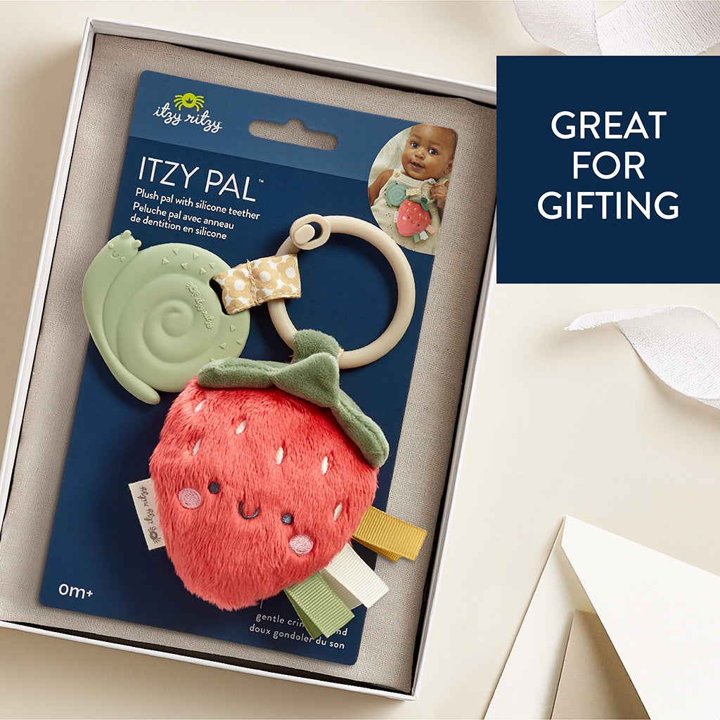 Strawberry-themed plush toy with silicone teether in packaging, labeled 'Itzy Pal', on a beige background.