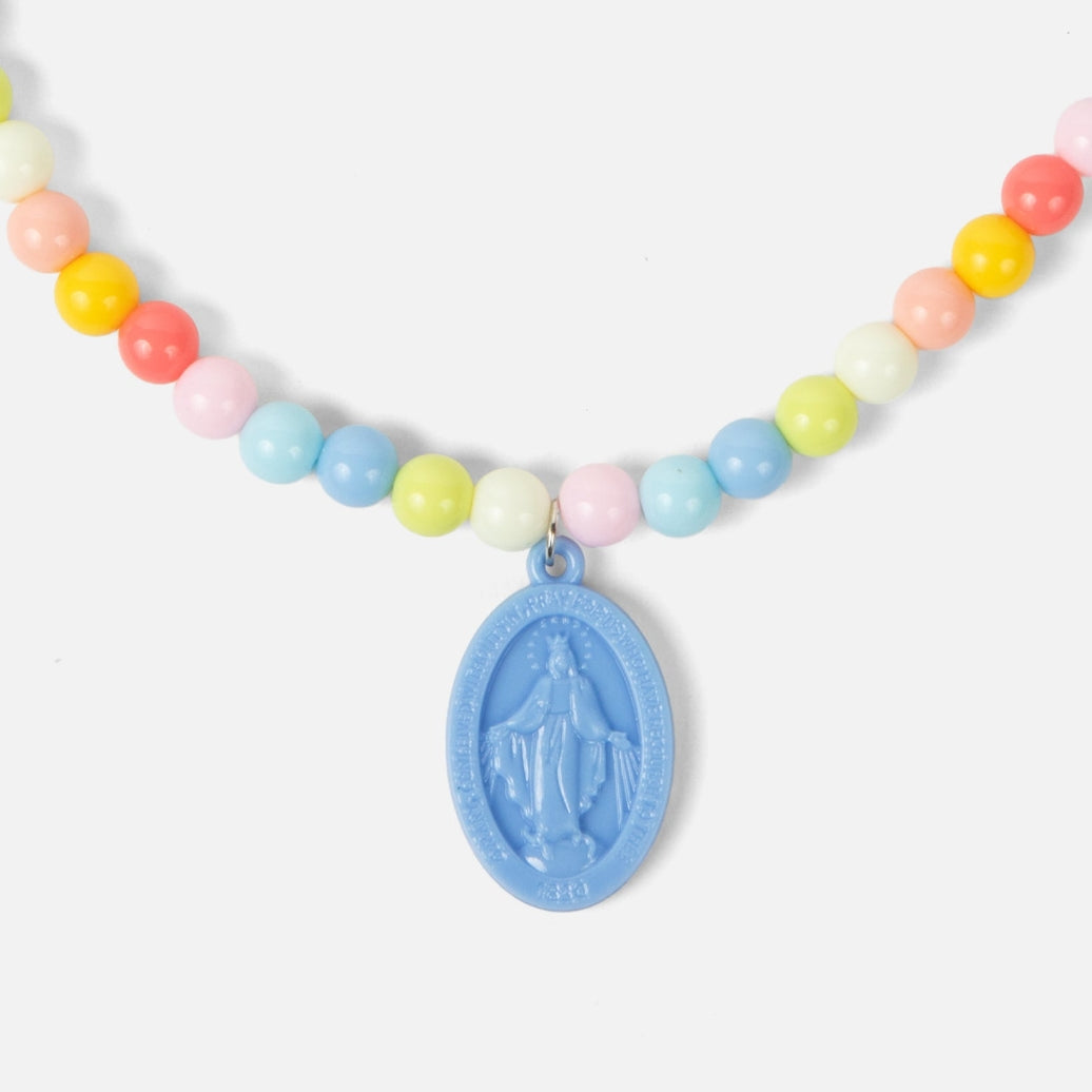 Necklace with colorful beads and a blue religious pendant on a white background