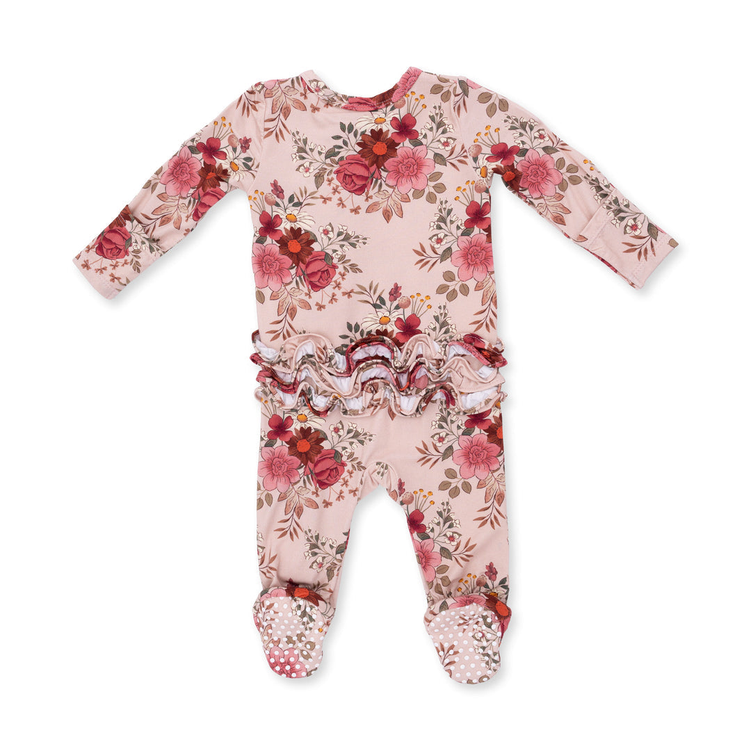 Floral patterned baby onesie on a white background