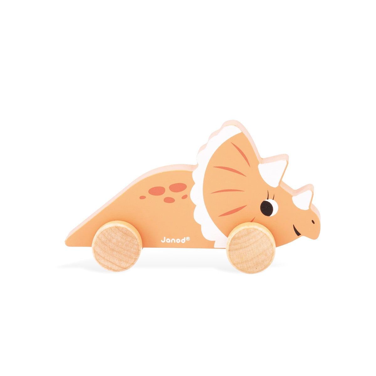 A wooden Triceratops toy car with natural wood wheels, featuring a light peach-colored body, a white frill, and a smiling face, shown on a white background with the Janod brand name visible.