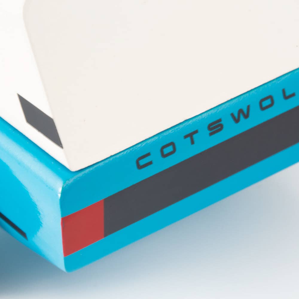 Close-up of a blue and white product with 'Cotswold' branding on a light gray background