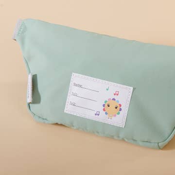 Green baby diaper with a label on a beige background
