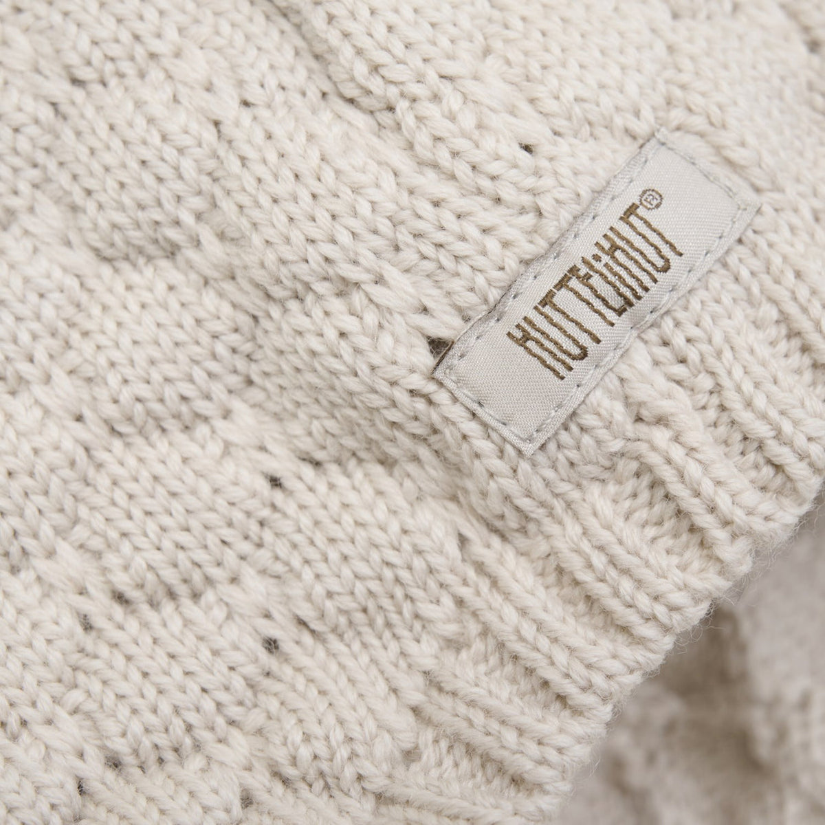 Close-up of a knit fabric with a visible brand label.