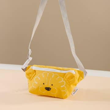 Yellow pouch with lion design on a beige surface
