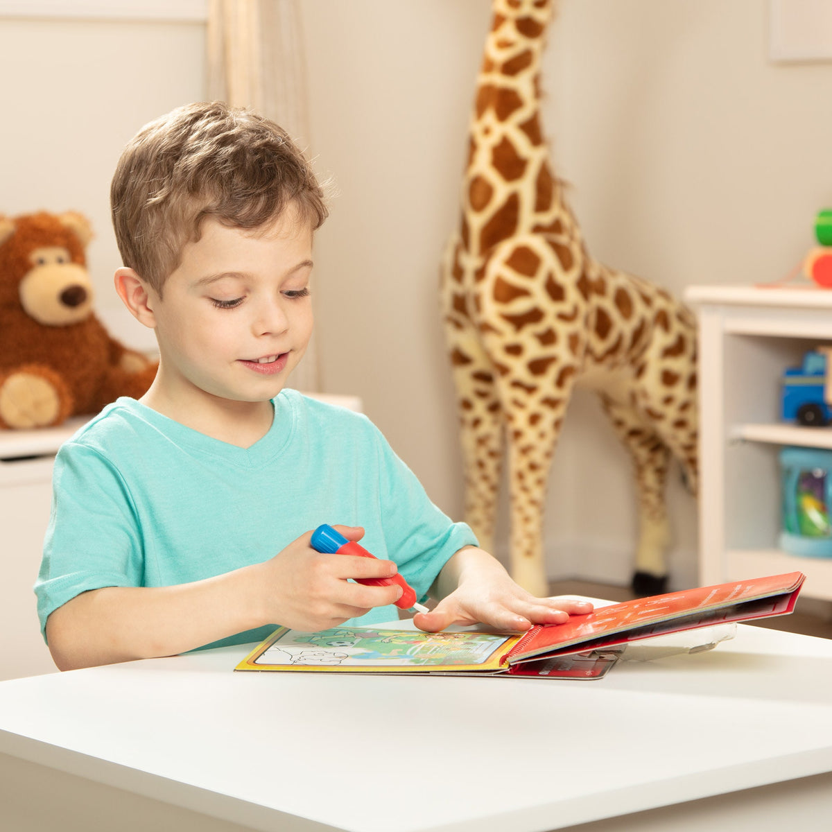 Child playing with toys at a table in a room with stuffed animals