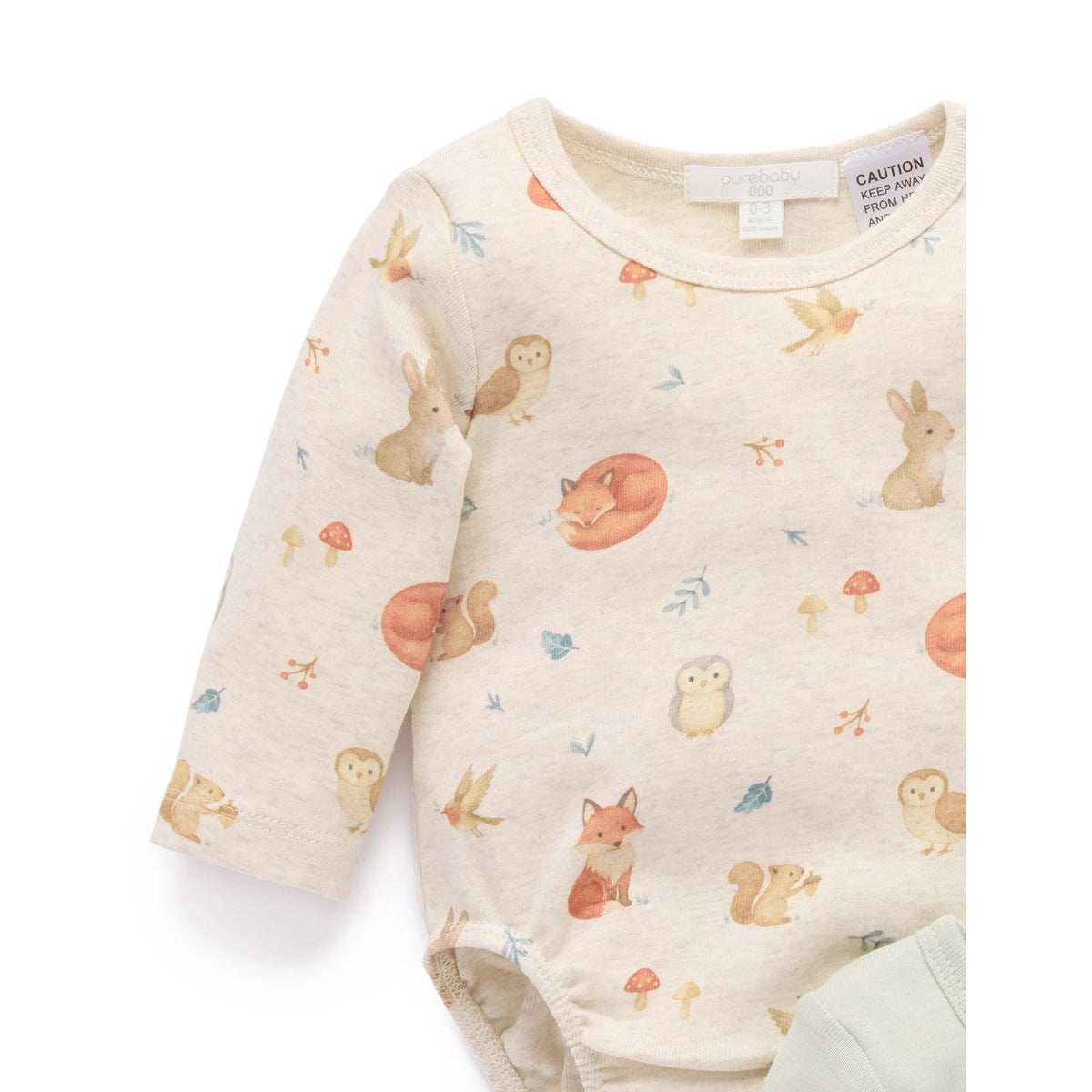 A long-sleeve baby bodysuit in cream with a cute woodland animal print featuring foxes, rabbits, owls, and mushrooms, shown on a clean white background.