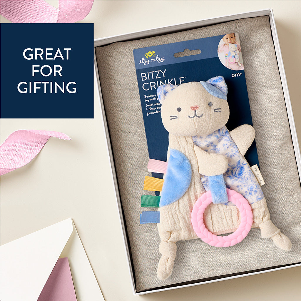 Cat-shaped baby toy with crinkle elements in packaging, labeled 'Bitzy Crinkle', on a light background.