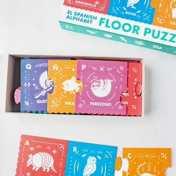 Children's Spanish alphabet floor puzzle with colorful boxes and animal illustrations.