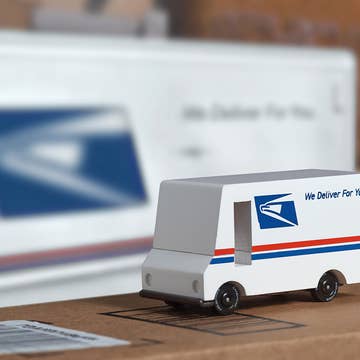 Model of a UPS delivery truck on a table with blurred background