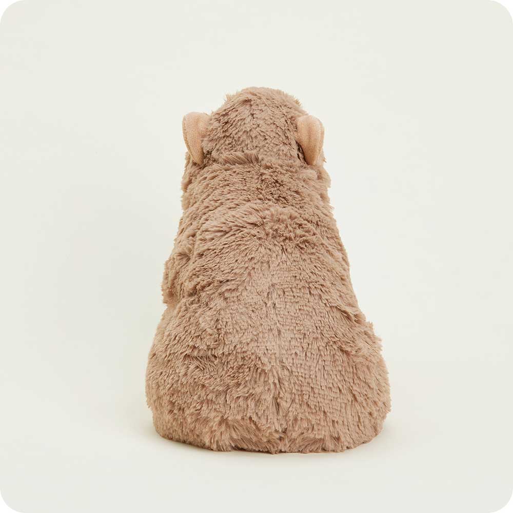 Plush toy resembling a dog from behind on a white background