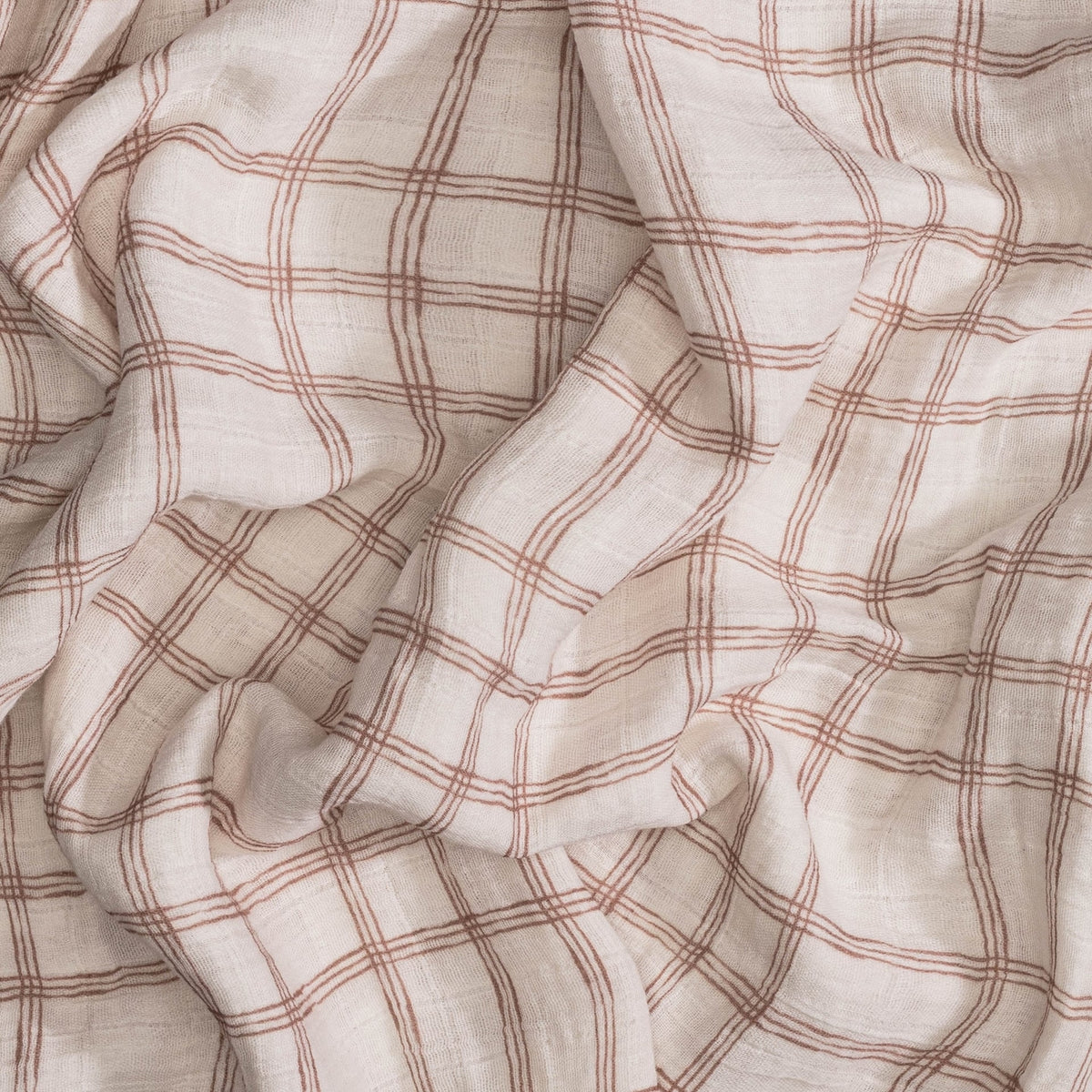 Close-up of beige fabric with red plaid pattern