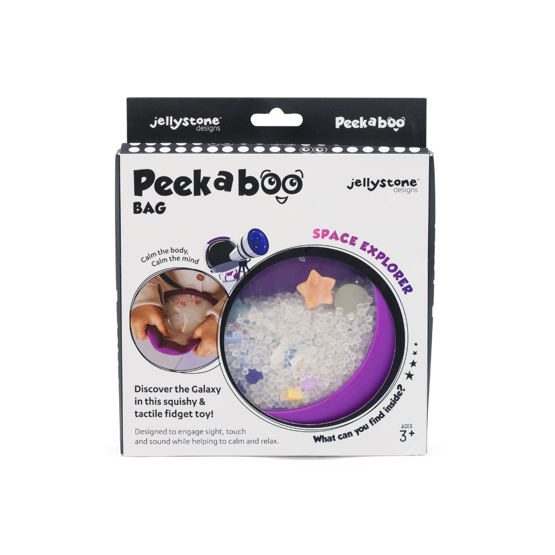 Peekaboo Space Explorer Slightly Sensitive toy in its original retail packaging by Jellystone Design, featuring a purple circular container filled with white textured balls and small star and planet toys.