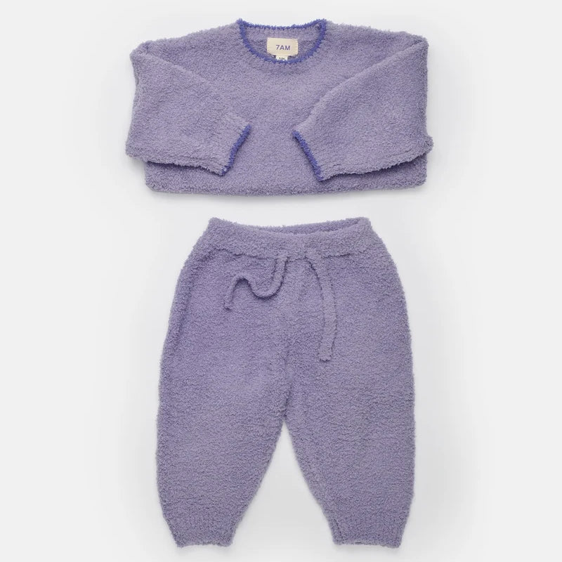 A complete taro purple fuzzy winter set arranged flat against a white background, featuring a boxy sweater and lounge pants with a matching drawstring.