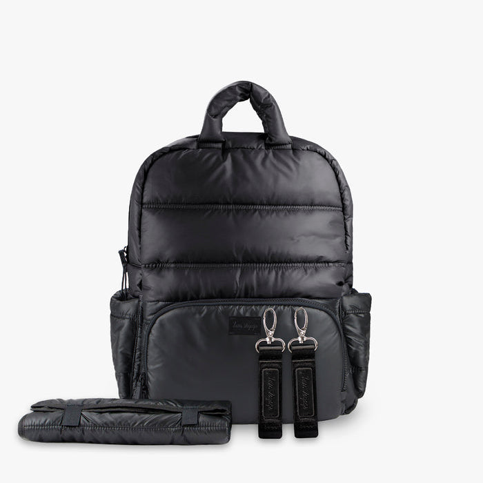Black backpack with a folded black mat on a white background