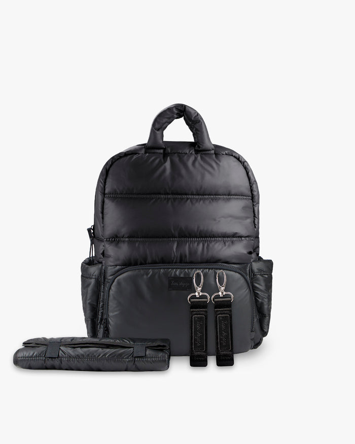 Black backpack with a folded black mat on a white background