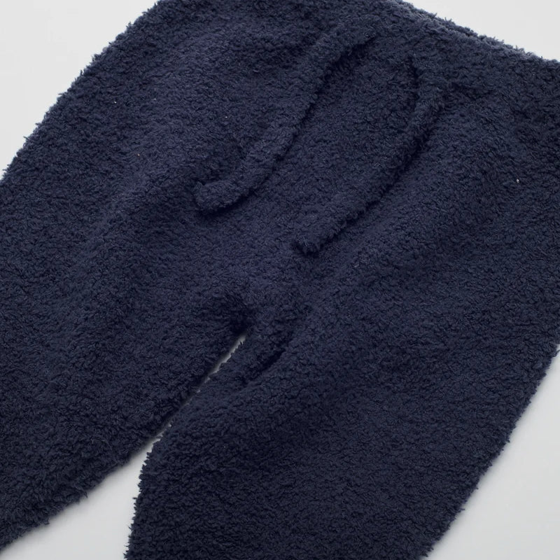 Navy blue fuzzy fleece pants with an elastic waistband and drawstring, shown against a plain white background.