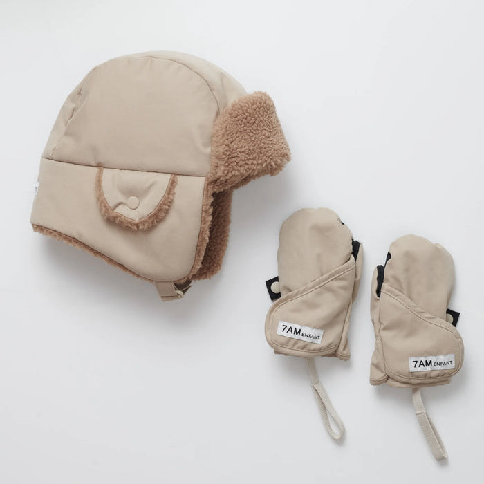 Beige winter hat and mittens set on a white background