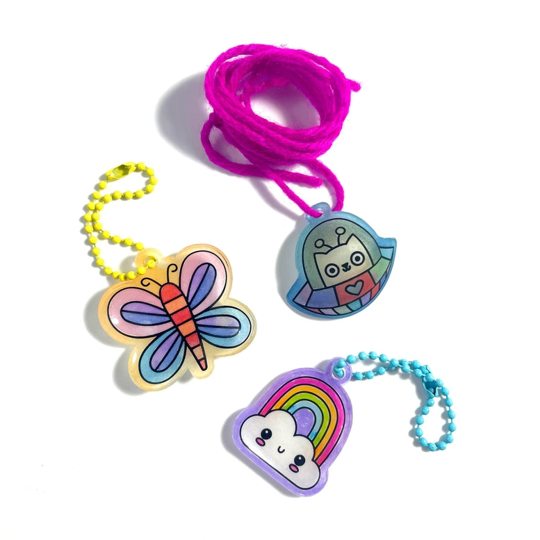 Colorful keychains with cartoon designs on a white background