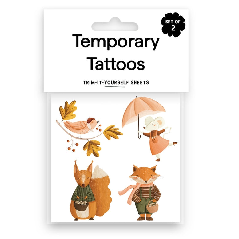 Pack of two temporary tattoos featuring autumn animal designs including a bird, mouse under an umbrella, squirrel, and fox, in a white hanging card package.