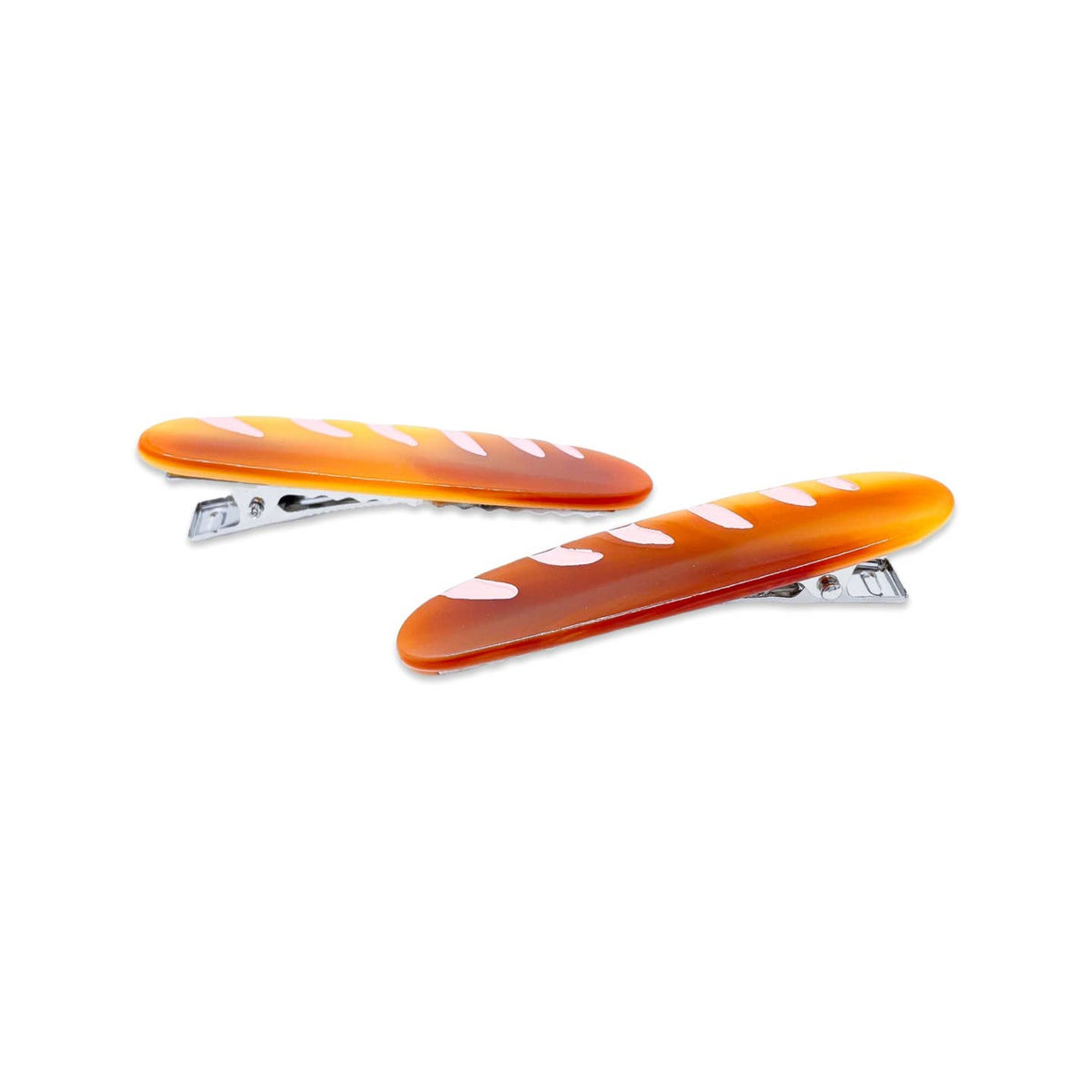 Two orange hair clips with white hearts on a white background