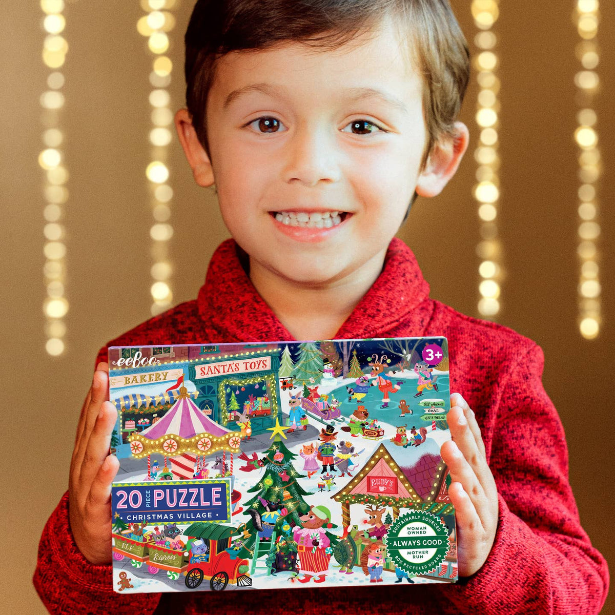 Child holding a Christmas-themed puzzle box with a festive background