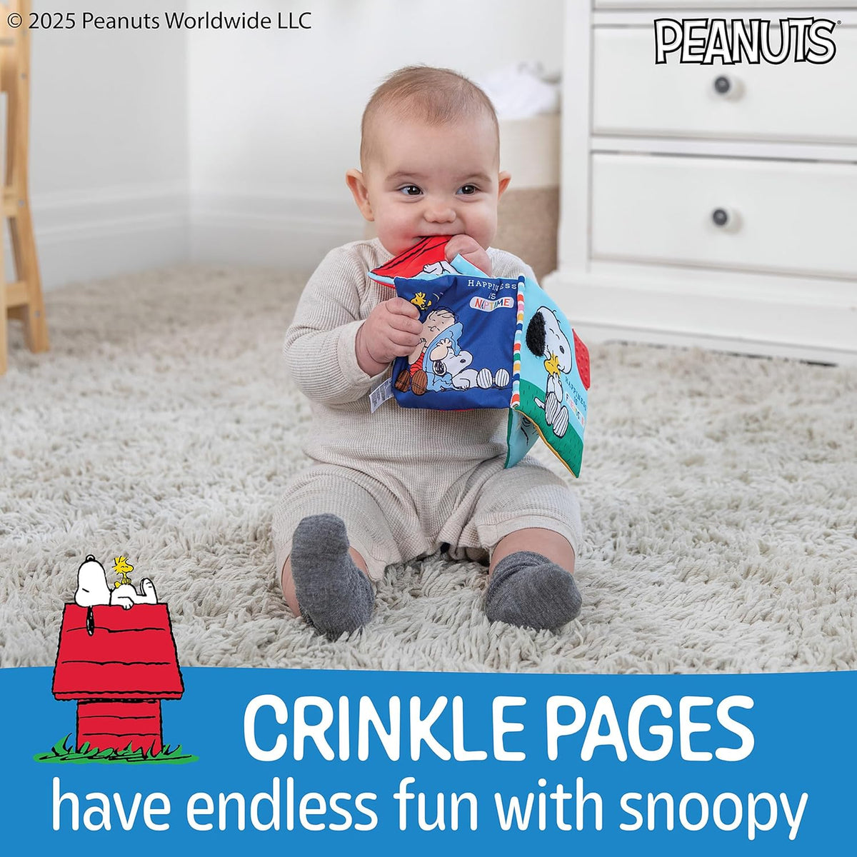 Baby holding a book with Snoopy on a carpeted floor, Peanuts branding visible.
