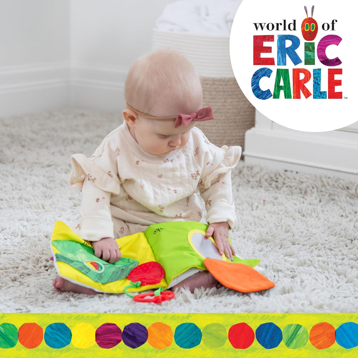 Baby playing with a colorful book, sitting on a carpeted floor with 'World of Eric Carle' logo.