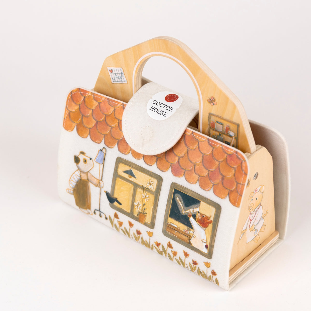 A wooden toy doctor's bag with a handle, featuring a house illustration, animal characters, and a white plastic clasp labeled 'DOCTOR HOUSE' on a clean white background.