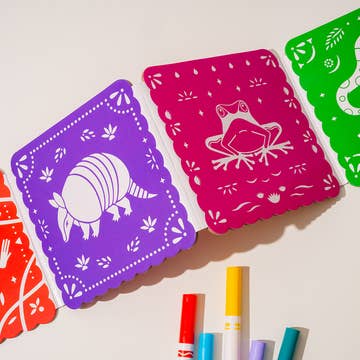 Colorful paper cutouts with animal illustrations on a light background