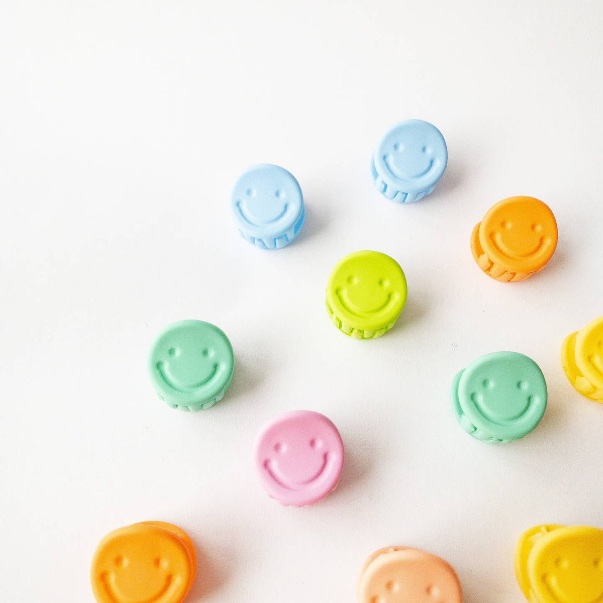 Colorful smiley face buttons on a white background