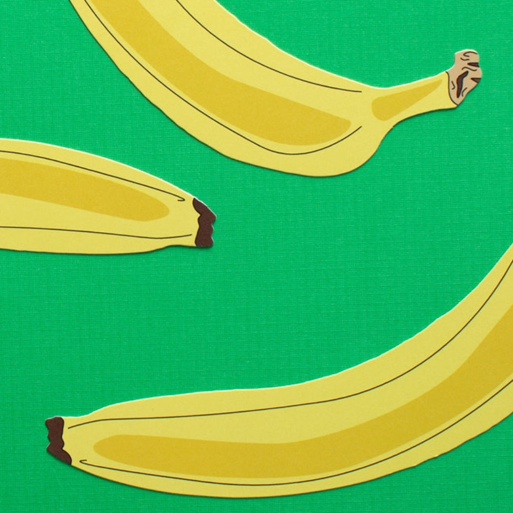 Three bananas on a green background