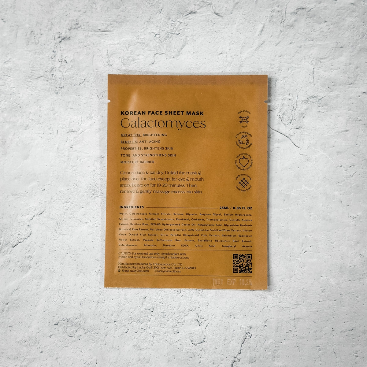 Korean face sheet mask packaging with text on a textured gray background
