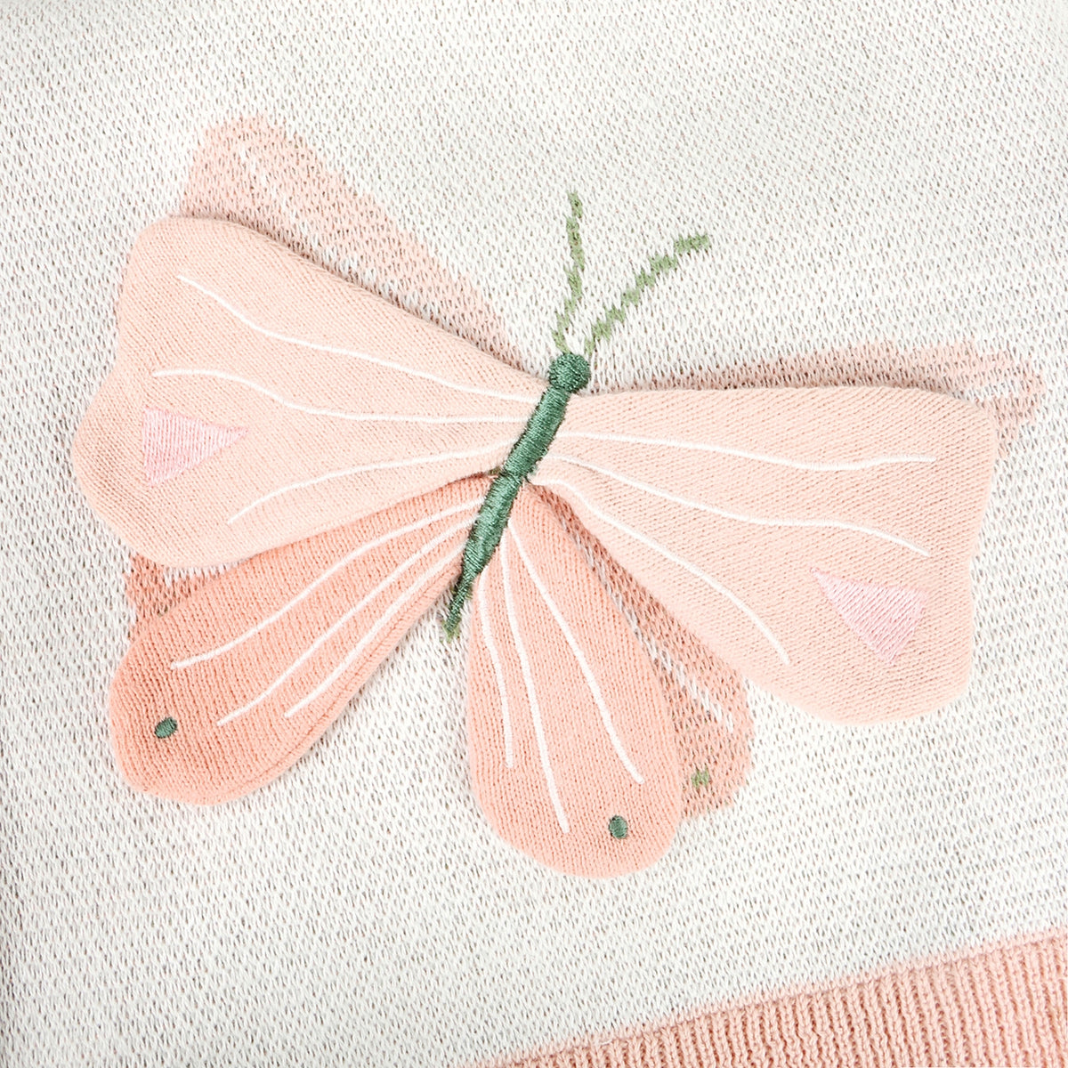 Embroidered butterfly design on fabric with pink wings and green body.
