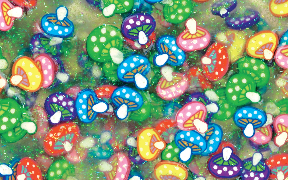 Colorful mushroom-shaped candies on a green background