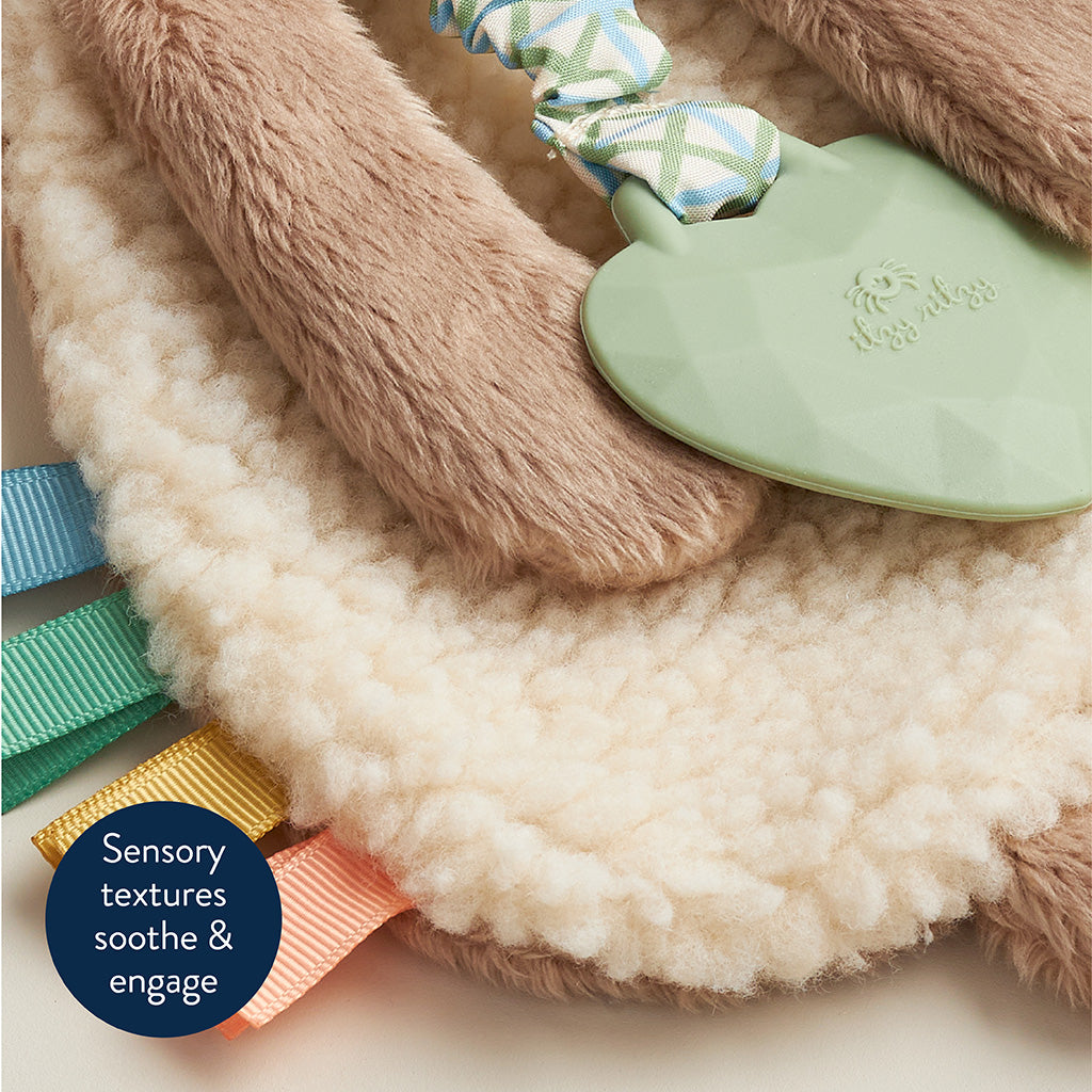 Sensory toy with textured elements and a plush surface on a light background