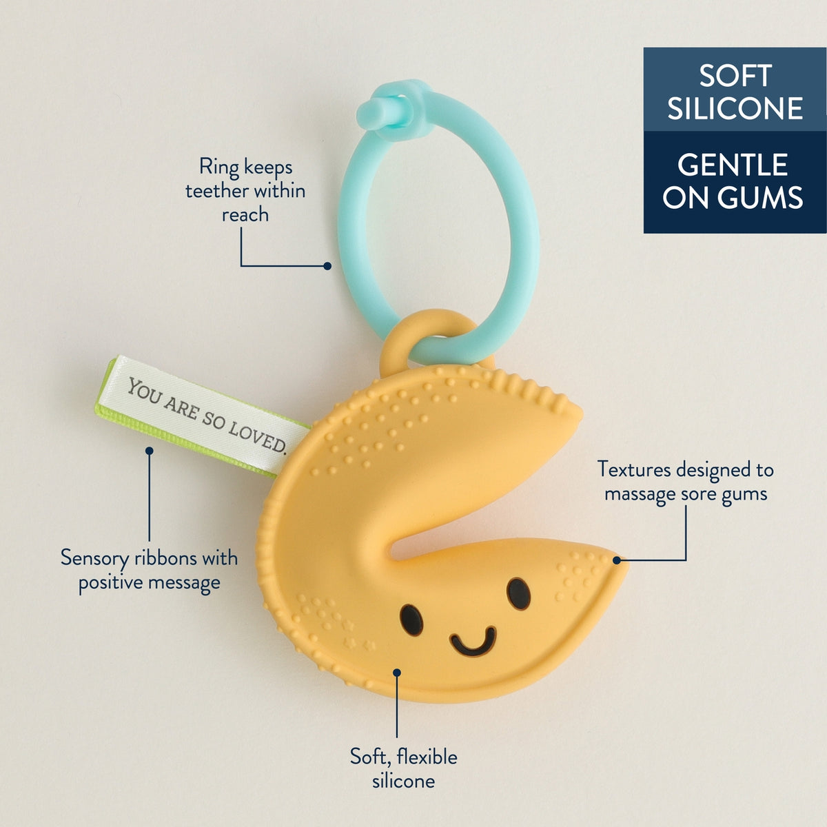 Yellow teething toy with smiley face design on a light gray background, featuring text about its features.