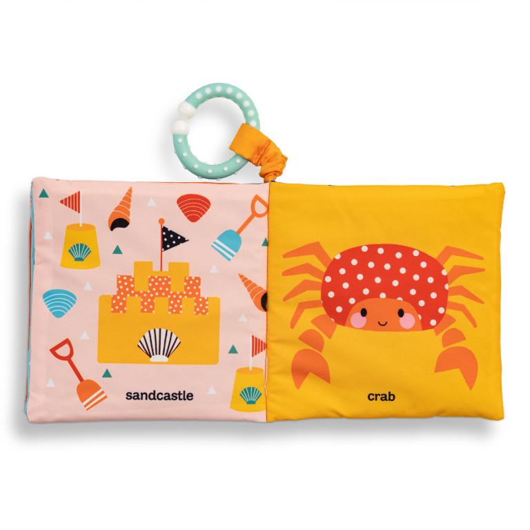 Children's soft book with sandcastle and crab illustrations on a white background