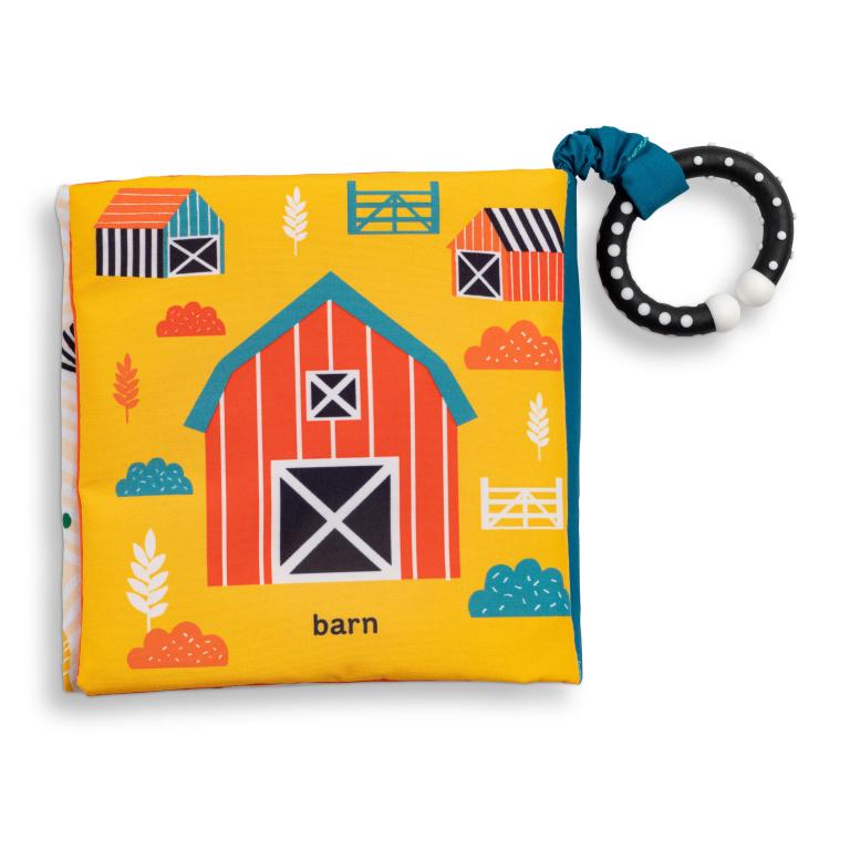 Children's book with a barn illustration and a teething ring on a white background