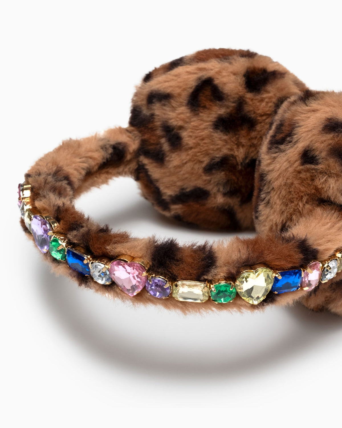 Brown leopard-print faux fur earmuffs with a row of colorful rhinestones on the band, photographed on a clean white background.
