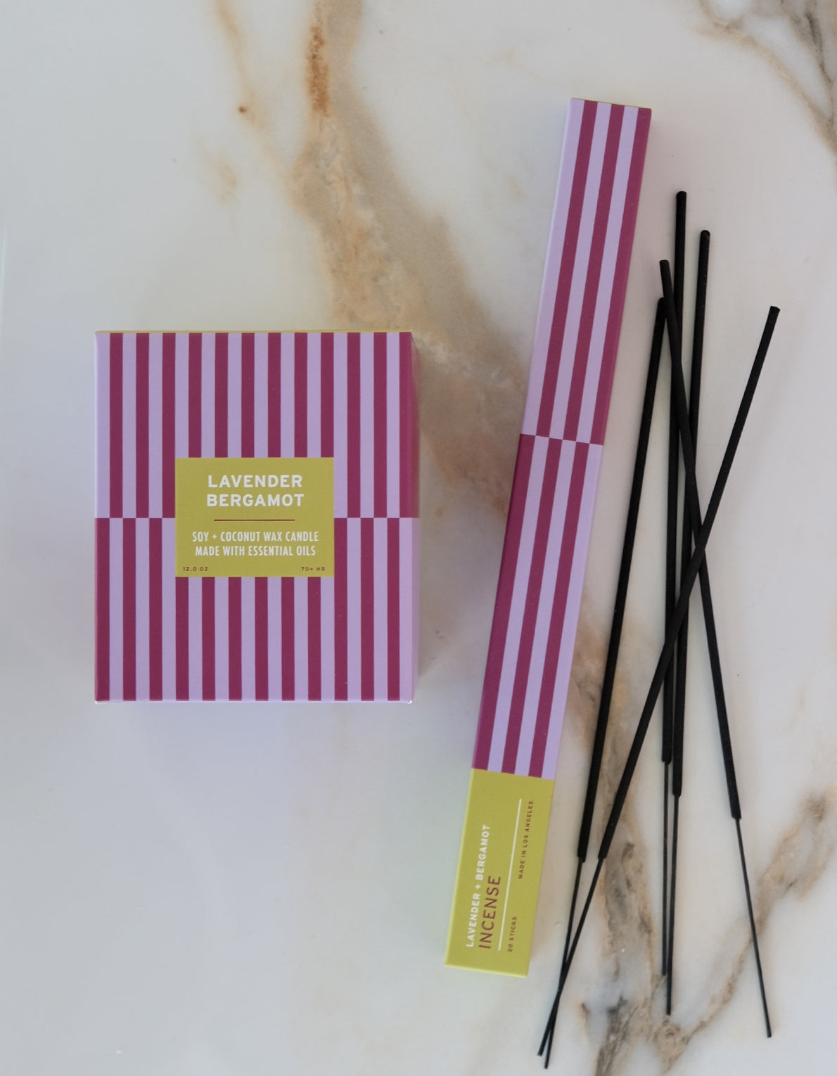 Lavender Bergamot candle packaging with incense sticks on a marble surface