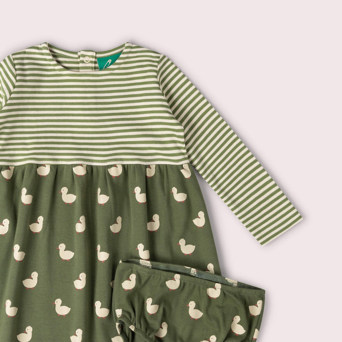 A two-piece baby girl's outfit set featuring a long-sleeve dress and matching bloomers. The dress has a top section with green and white horizontal stripes and a bottom section in olive green with a repeating duck print.