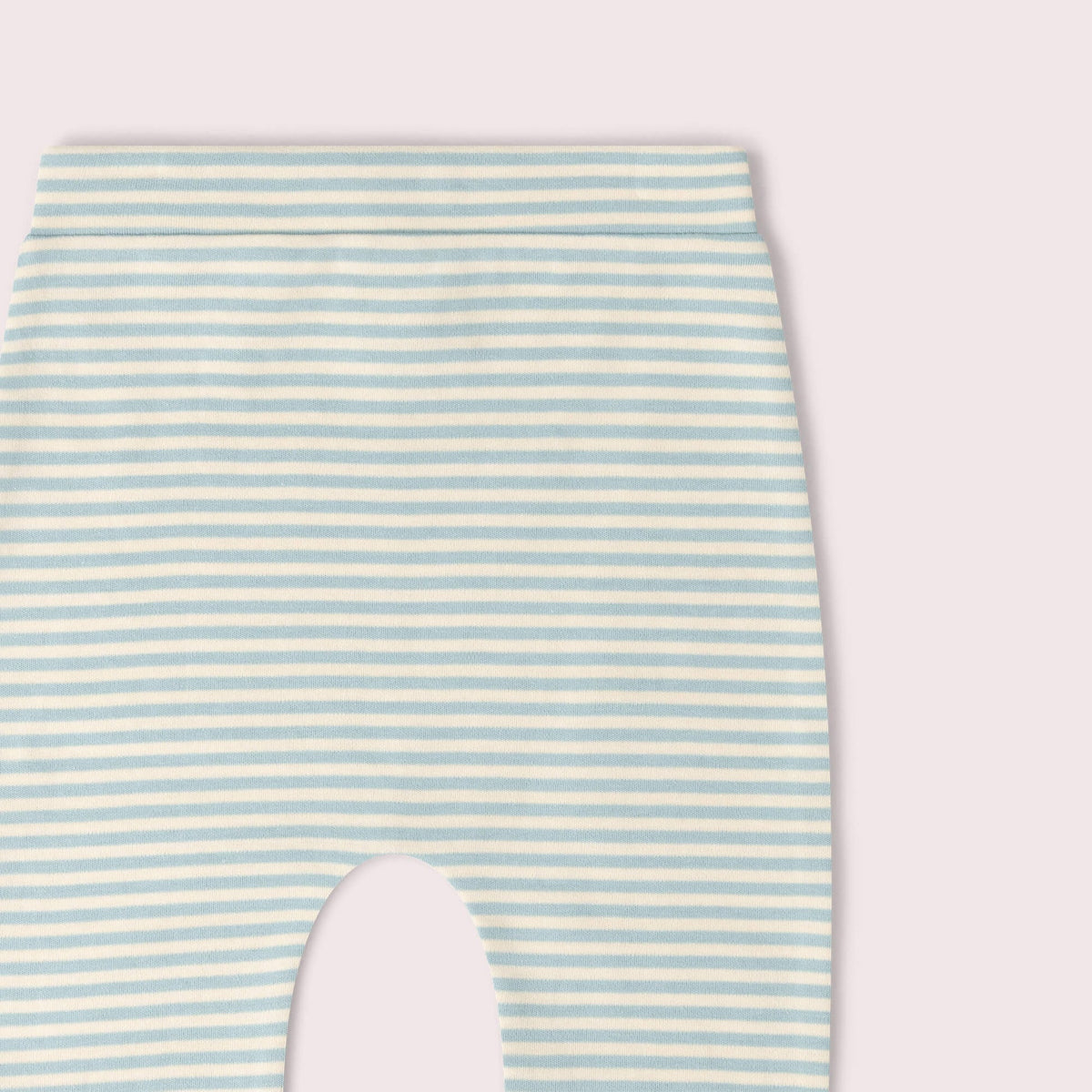 Close-up of a baby garment with horizontal mint green and white stripes.