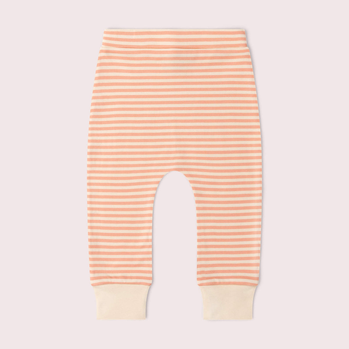 Baby pants with peach and cream horizontal stripes and solid cream ribbed cuffs, shown flat against a pale pink background.