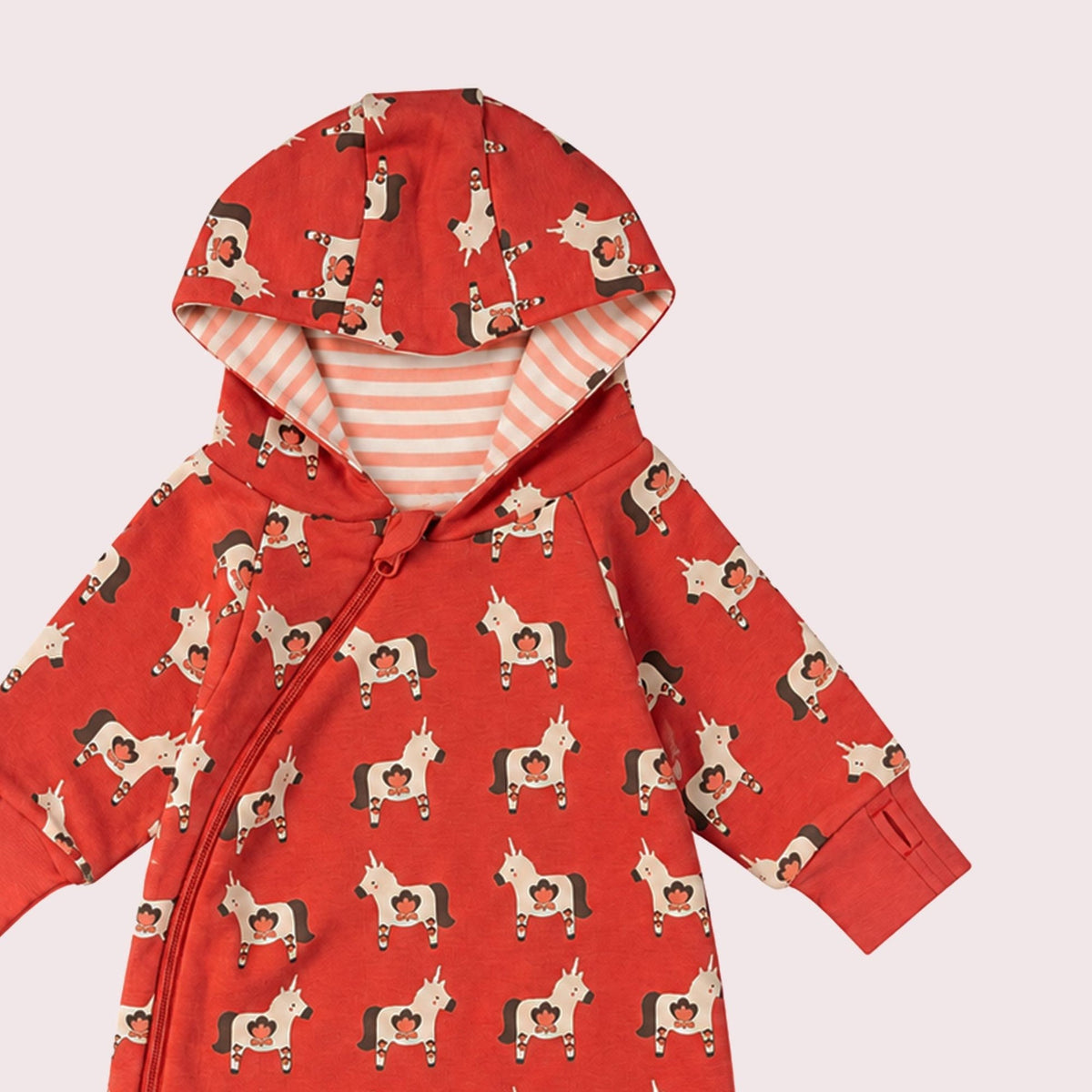 A baby hooded one-piece romper in red with an all-over dog print, featuring a striped hood lining and a front zipper, shown on a plain white background.
