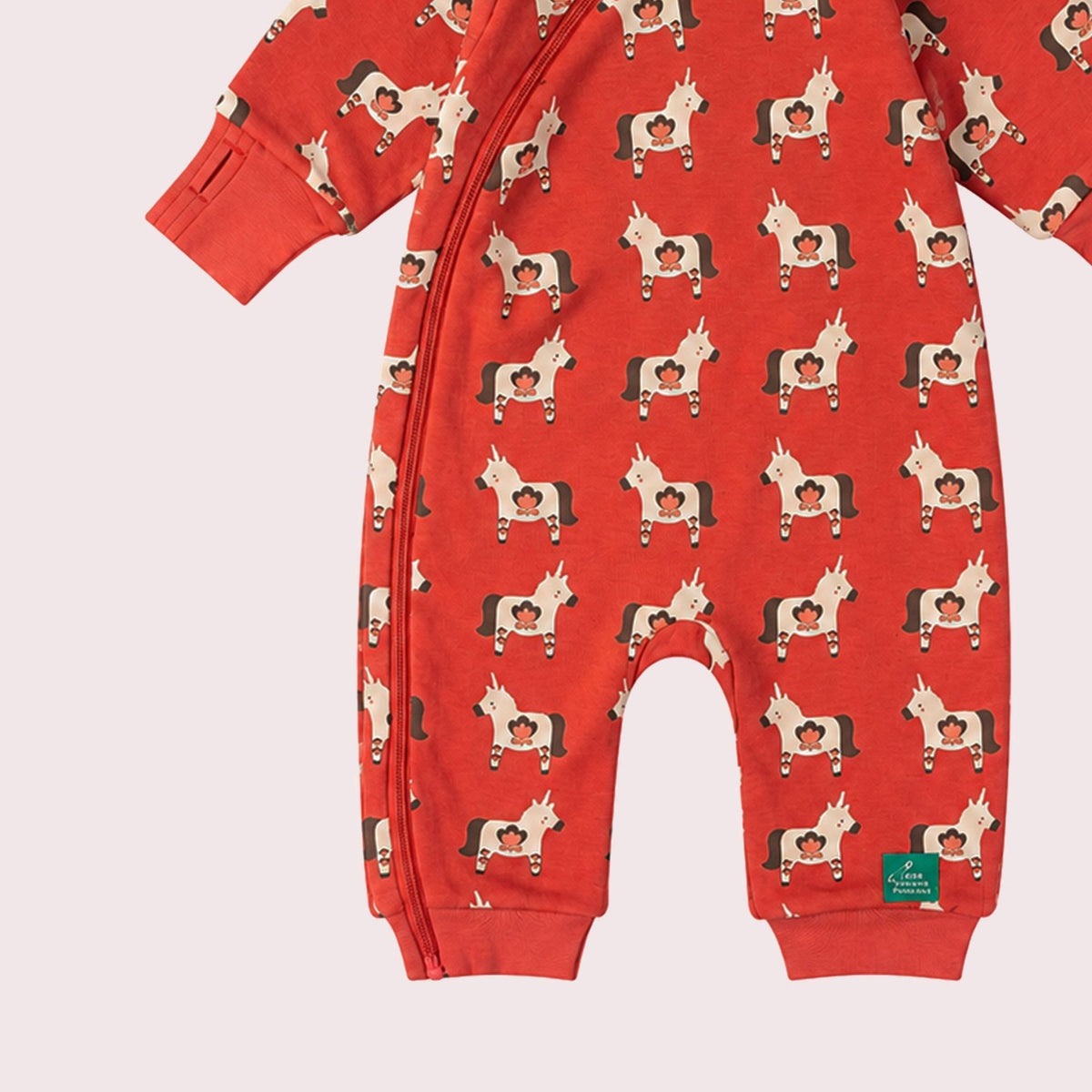 A baby hooded one-piece romper in red with an all-over dog print, featuring a striped hood lining and a front zipper, shown on a plain white background.