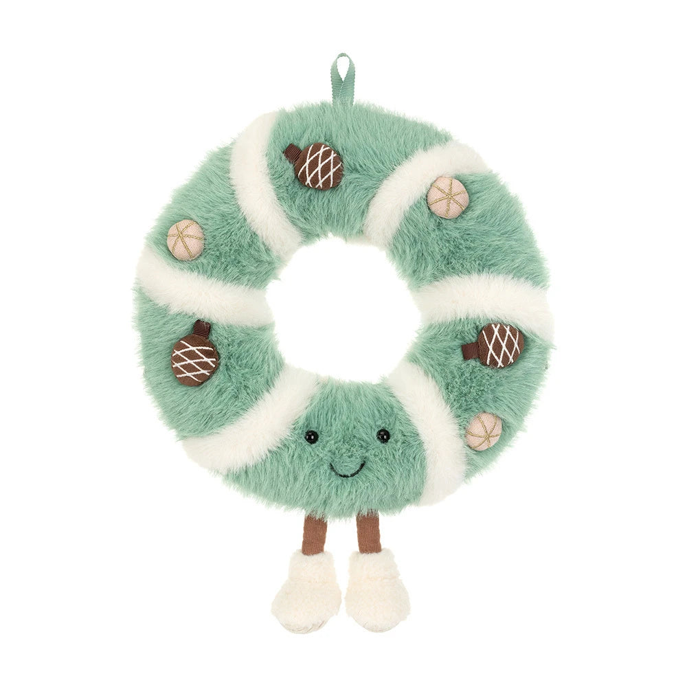 A plush donut-shaped hanging decoration in mint green and white faux fur, with embroidered facial features, small brown acorn appliqués, and tan nut illustrations, shown on a plain white background.